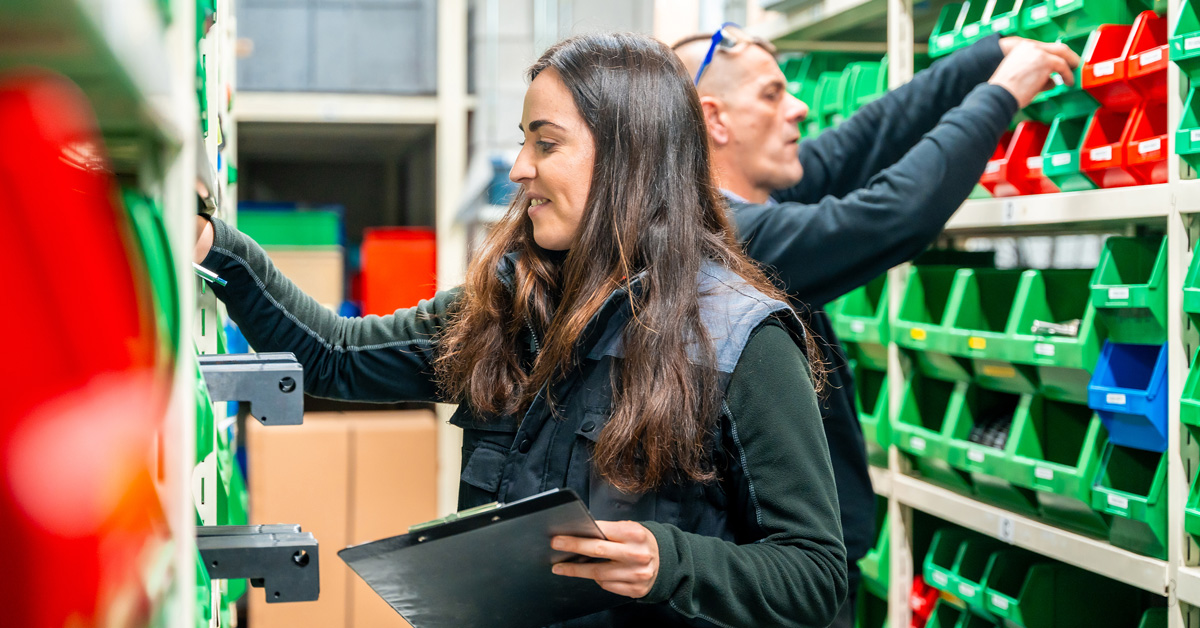 woman-organizing-inventory-in-a-warehouse A woman organizes inventory in a warehouse.